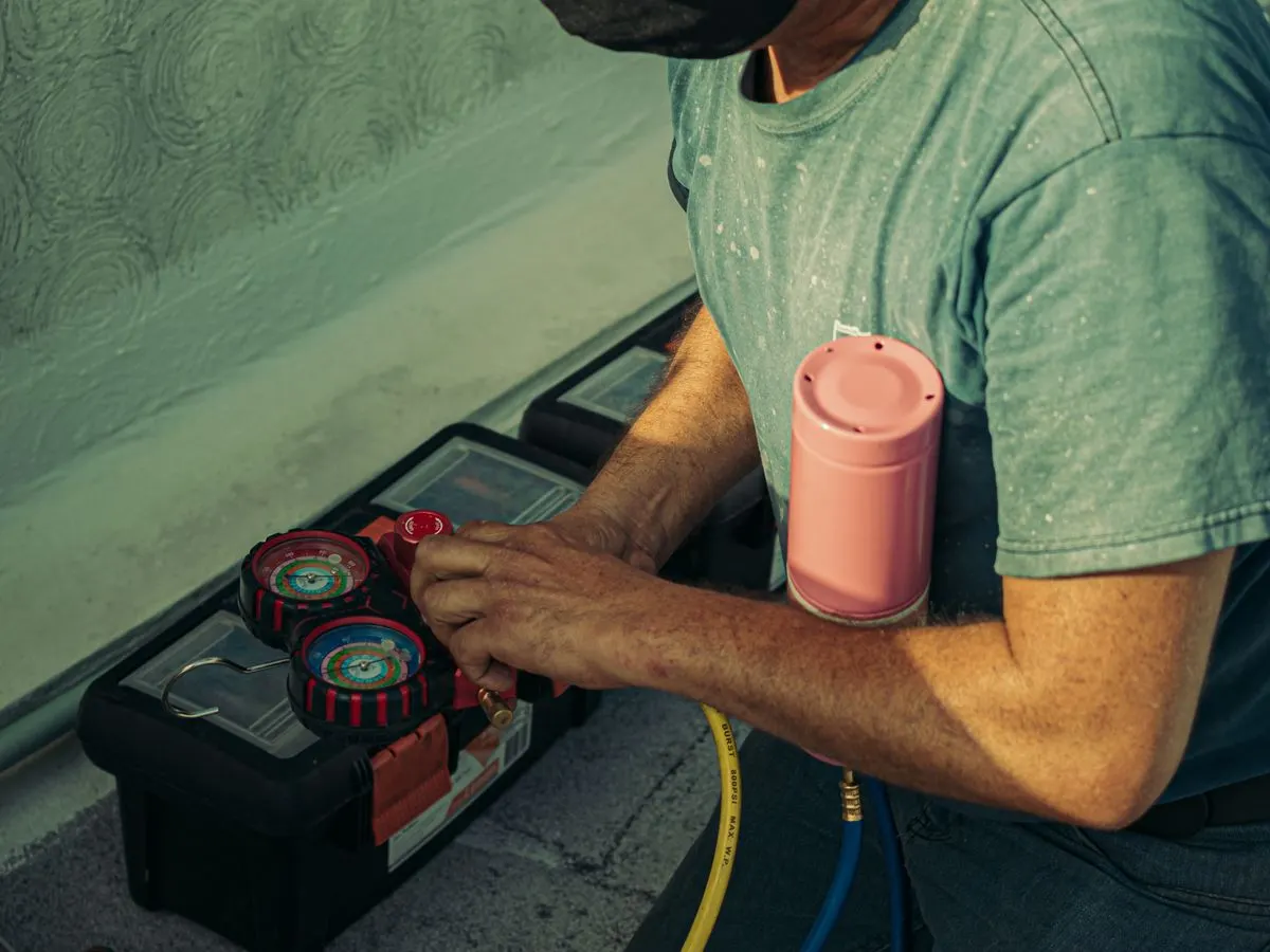 A technician performing a seasonal air conditioning tune-up