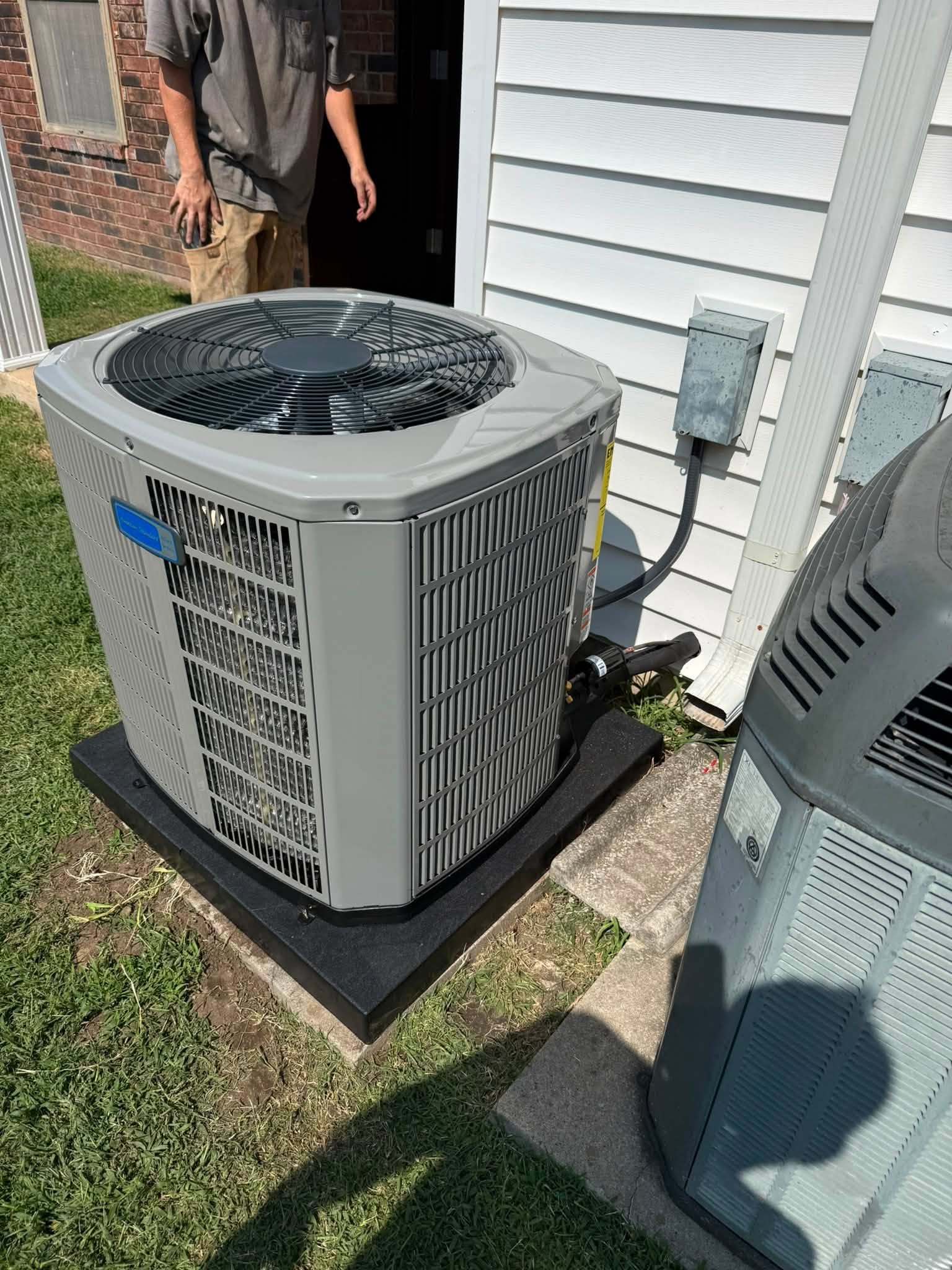 Newly installed high-efficiency air conditioning condenser beside a Houston home